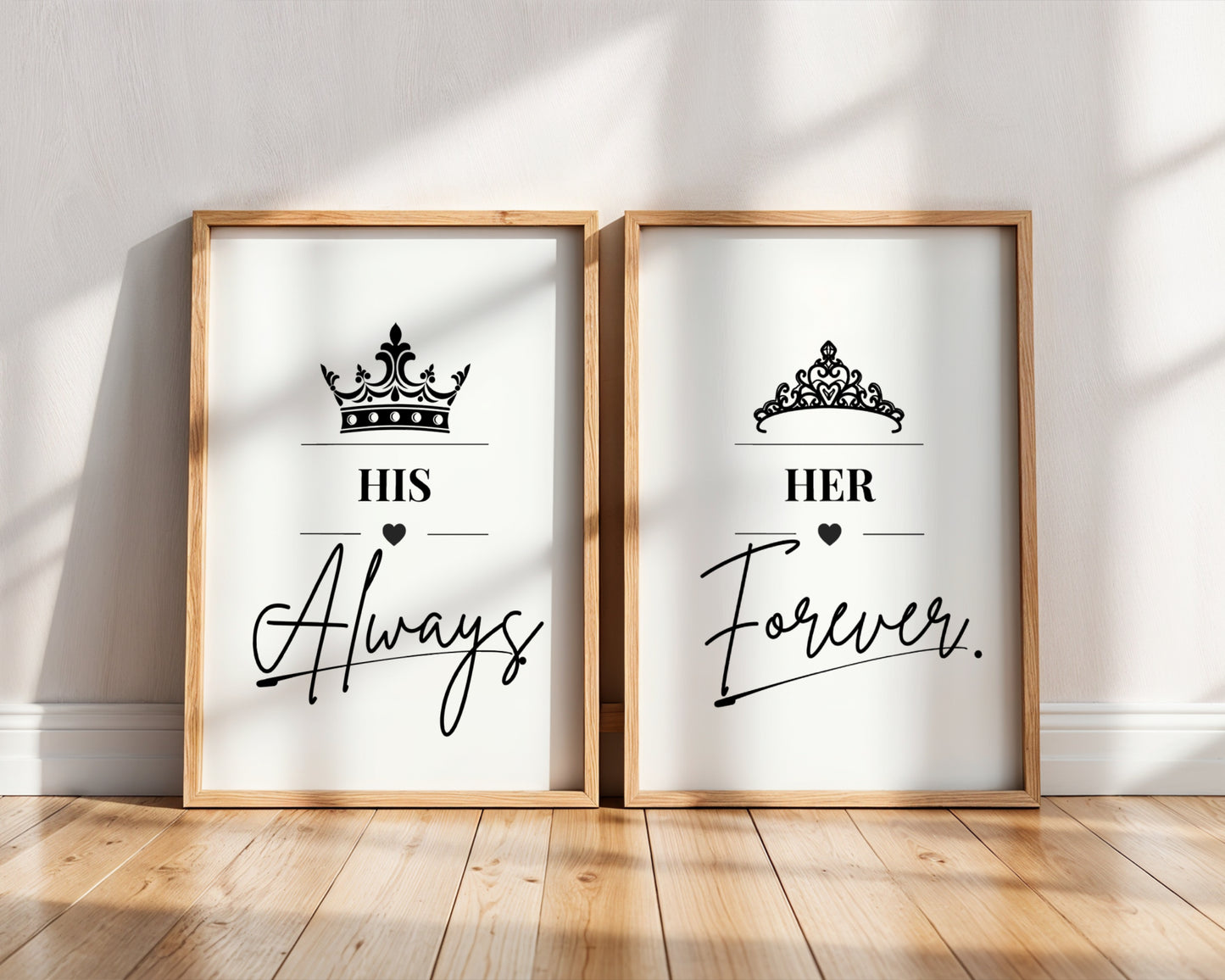 Two framed wall art prints leaning against a white wall on a light wood floor. The left print says "HIS Always" with a crown above, and the right print says "HER Forever.