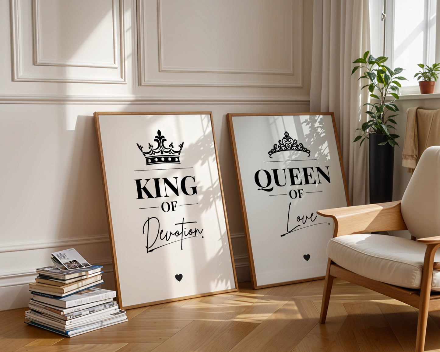 Two framed wall art prints leaning against a cream paneled wall in a sunlit room. The left print says "KING Of Her Soul" with a crown graphic, and the right print says "QUEEN Of His Soul" with a tiara graphic.