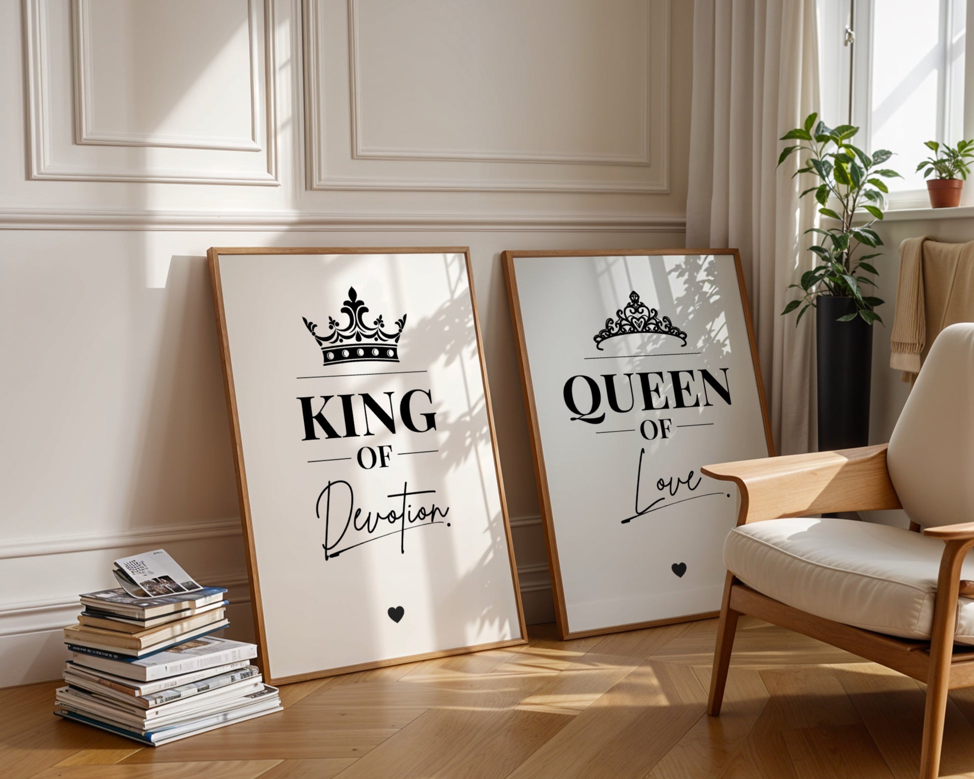Two framed wall art prints leaning against a cream paneled wall in a sunlit room. The left print says "KING Of Her Soul" with a crown graphic, and the right print says "QUEEN Of His Soul" with a tiara graphic.