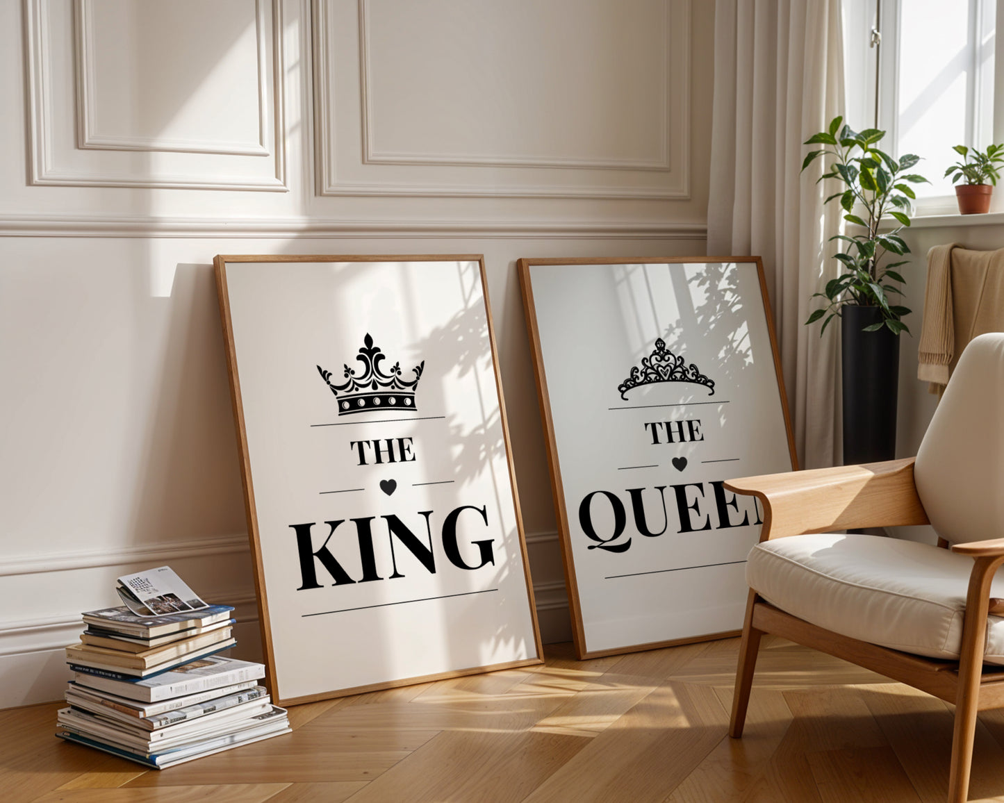 Two framed wall art prints leaning against a cream paneled wall in a sunlit room. The left print says “HER KING” with a crown graphic, and the right print says “HIS QUEEN” with a tiara graphic.