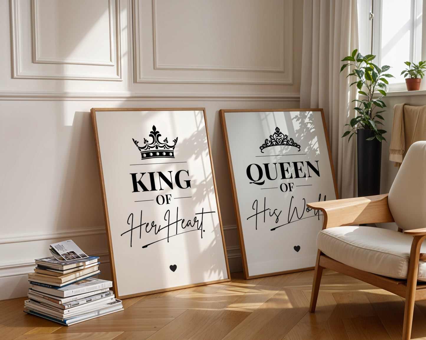 Two framed motivational wall art prints leaning against a cream paneled wall in a styled room. The left print says 'KING OF Her Heart' with a crown graphic, and the right print says 'QUEEN OF His World' with a crown graphic.