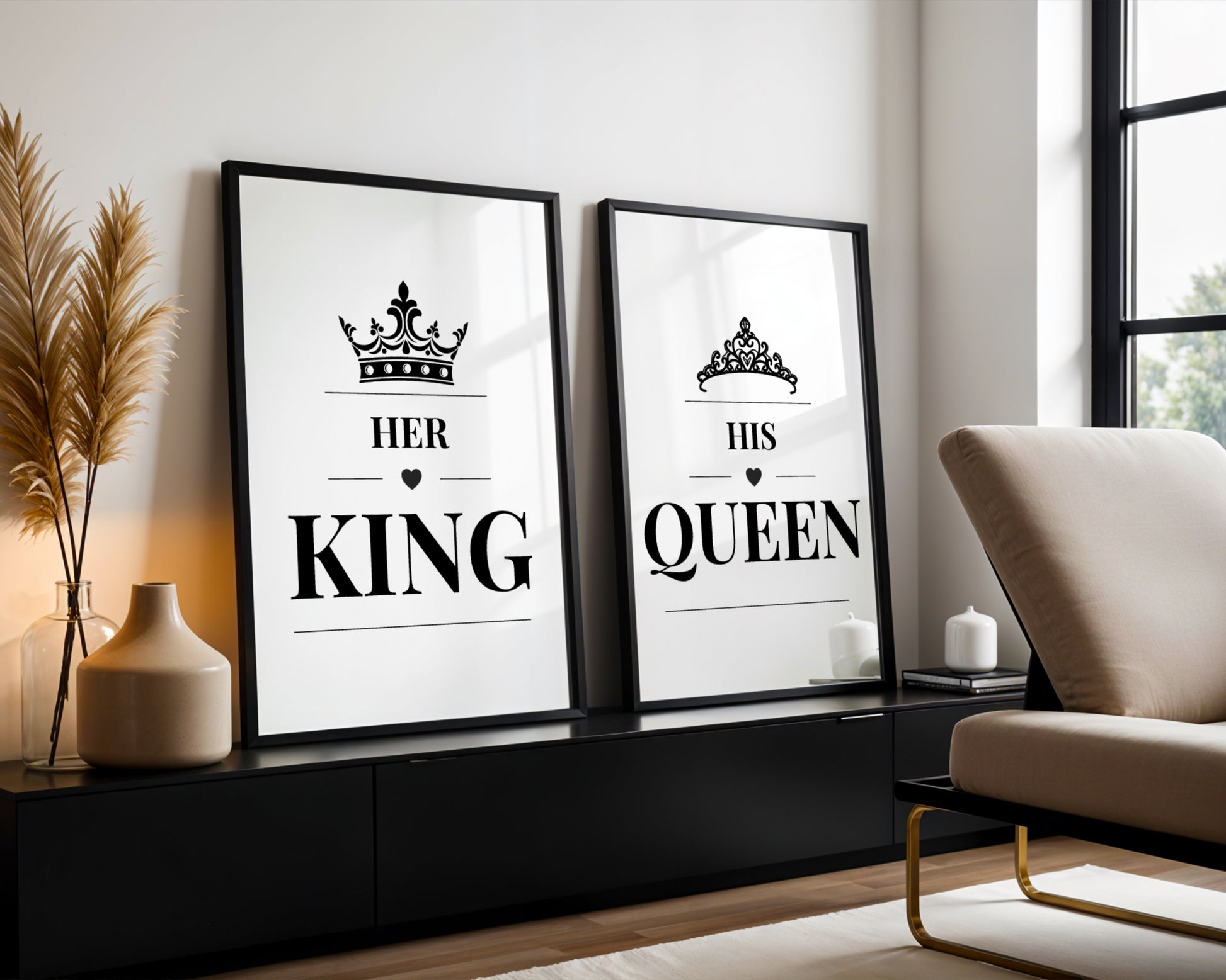 Two framed black-and-white decorative wall prints leaning against a wall in a modern living room. The left print reads “HER KING” with a crown above, and the right print reads “HIS QUEEN” with a crown above.