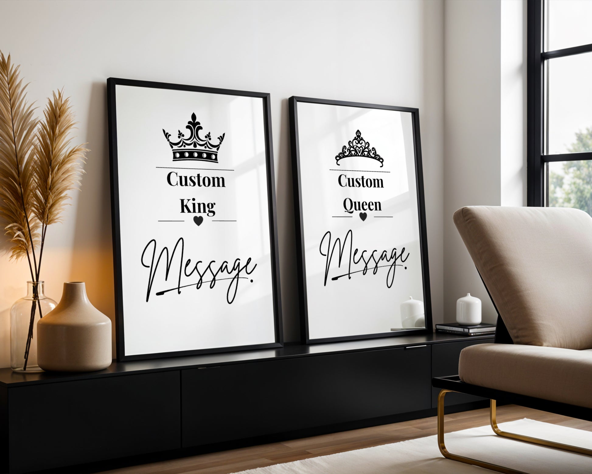 Two framed custom prints leaning against a wall in a modern living room setting. The left print features a crown icon and the text 'Custom King Message', while the right print features a tiara icon and the text 'Custom Queen Message'.