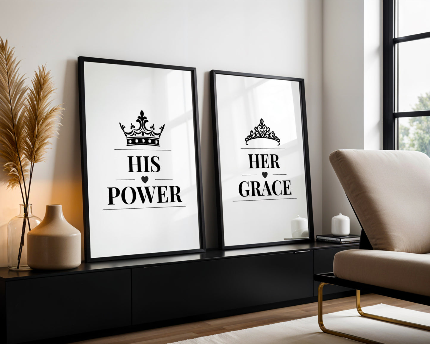 Two framed black-and-white typography wall art prints leaning against a wall in a modern living room. The left print reads "HIS POWER" with a crown above, and the right print reads "HER GRACE" with a tiara above.