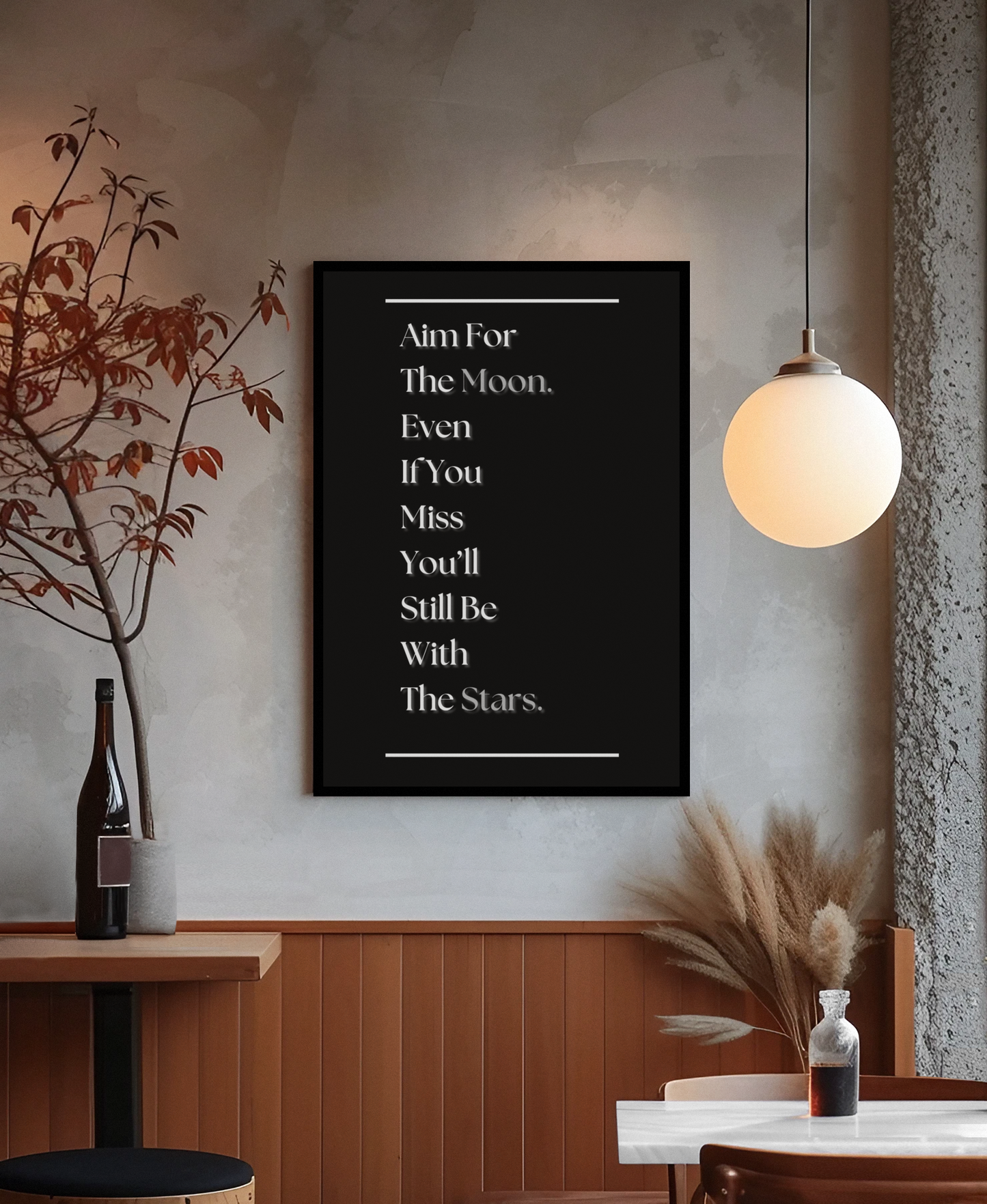A black framed wall art print with white text reading 'Aim For The Moon. Even If You Miss You'll Still Be With The Stars.
