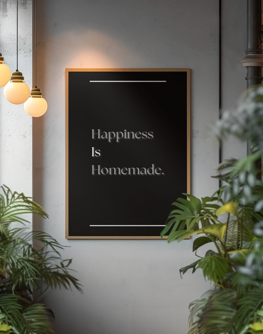 A framed motivational wall art print with the quote 'Happiness Is Homemade', displayed on a gray wall, surrounded by green plants and warm hanging pendant lights.