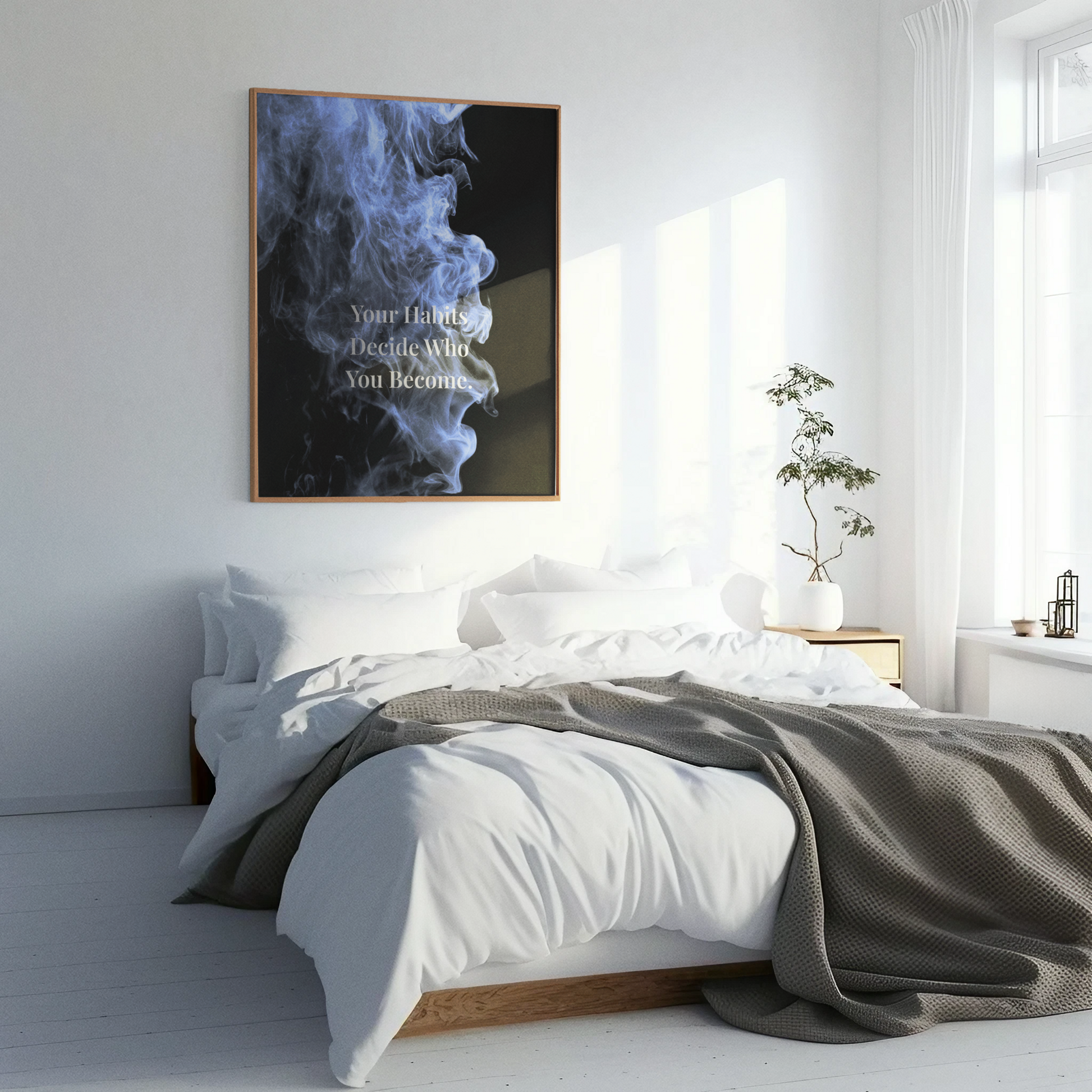 A framed wall art print featuring a dark smoky abstract design with the text 'Your Family Decides Who You Become' displayed in a bright, modern bedroom setting.