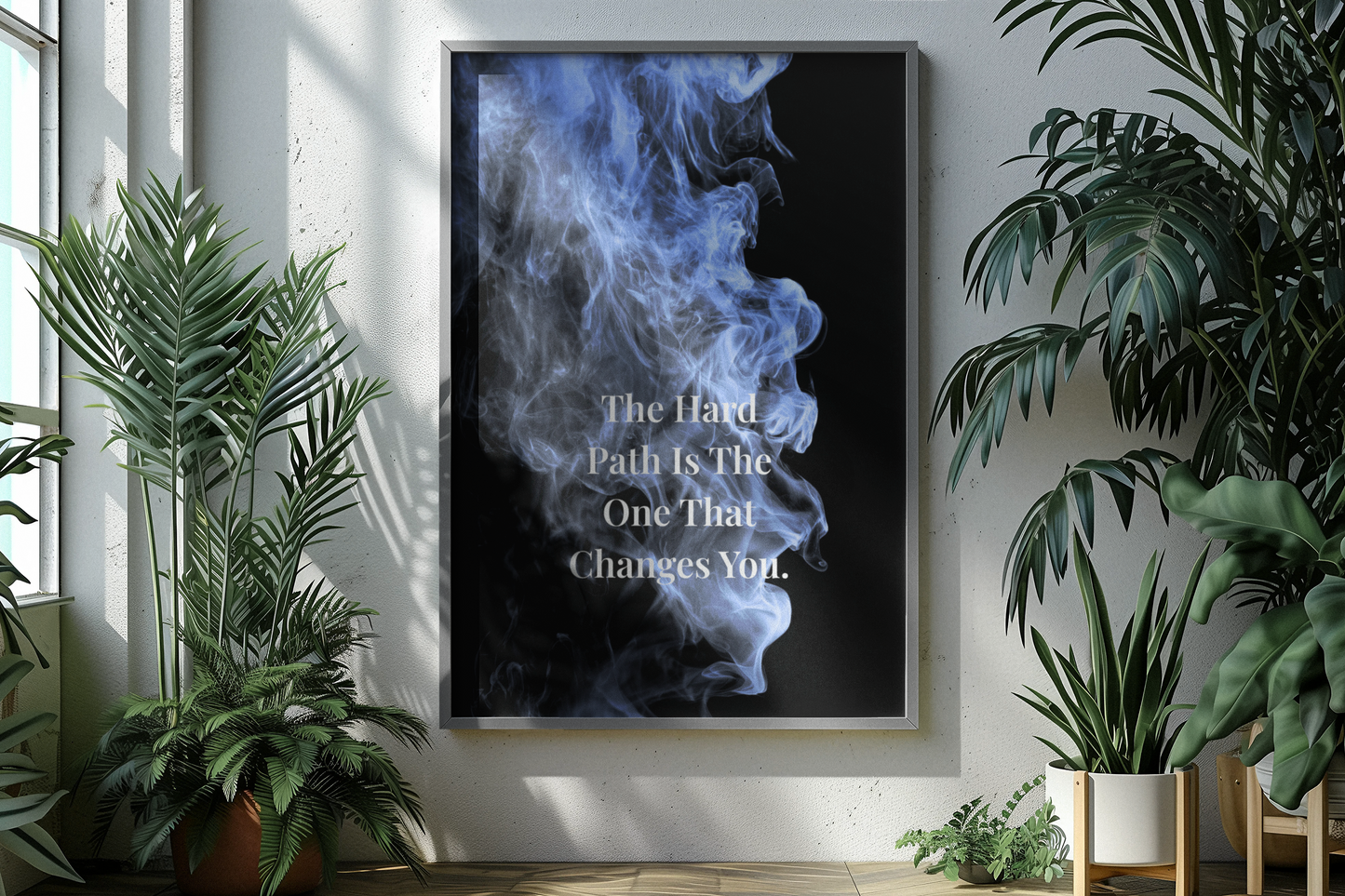 A framed vertical wall art print hangs on a light wall in a styled interior. The print shows a black background with blue smoke and the typography.