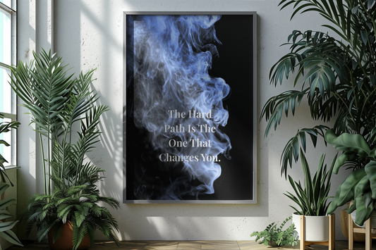A framed vertical wall art print hangs on a light wall in a styled interior. The print shows a black background with blue smoke and the typography.