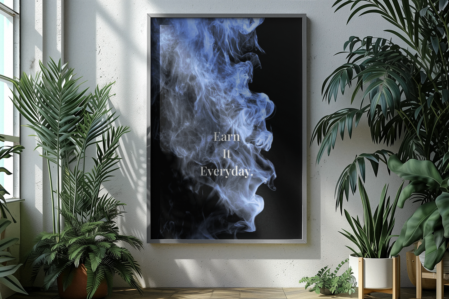 A framed vertical wall art print hangs on a light wall in a styled interior. The print shows a black background with blue smoke and the typography.