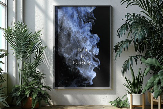 A framed vertical wall art print hangs on a light wall in a styled interior. The print shows a black background with blue smoke and the typography.