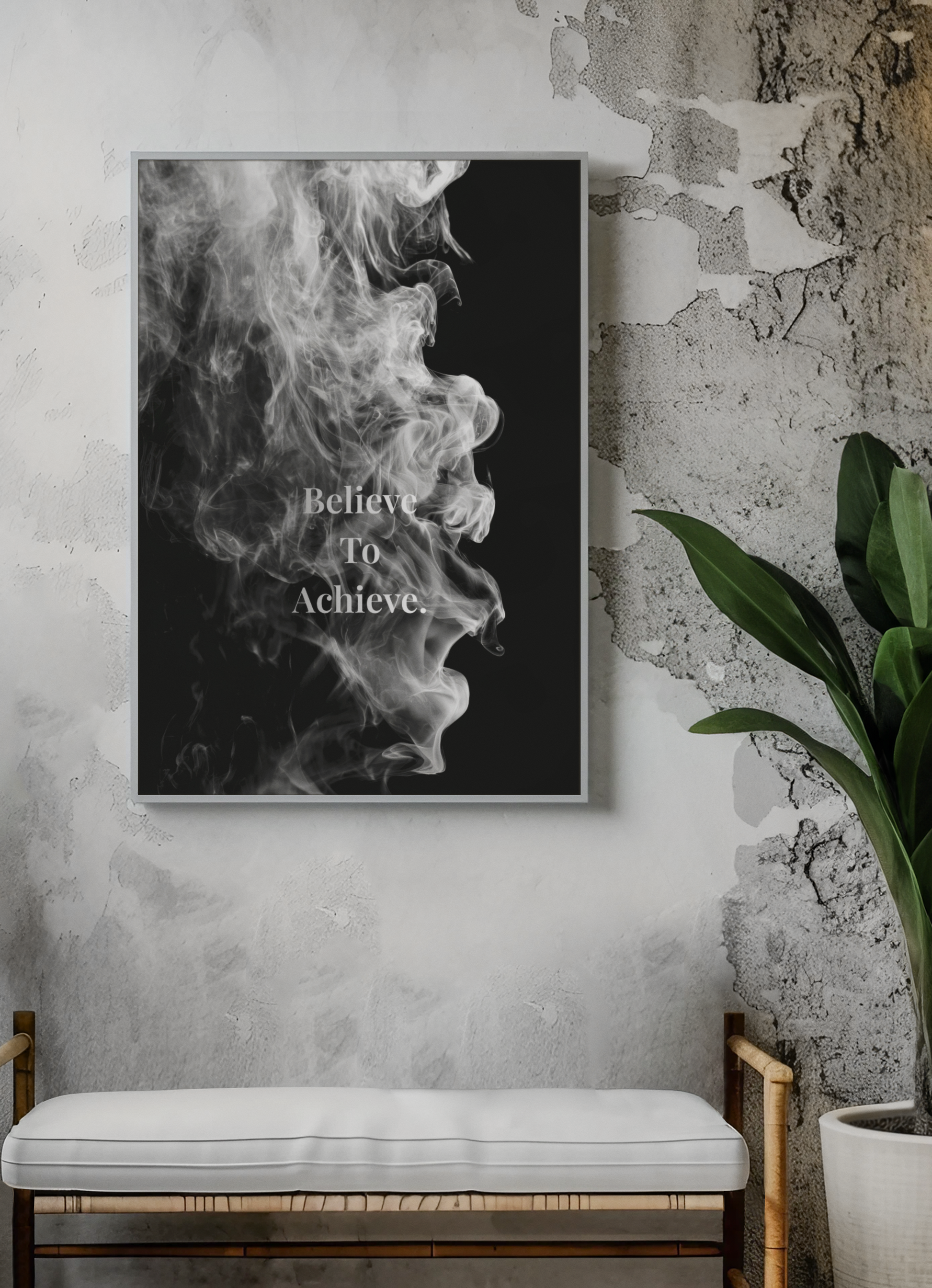 A framed black and white art print featuring a smoke profile with the text 'Believe To Achieve'.
