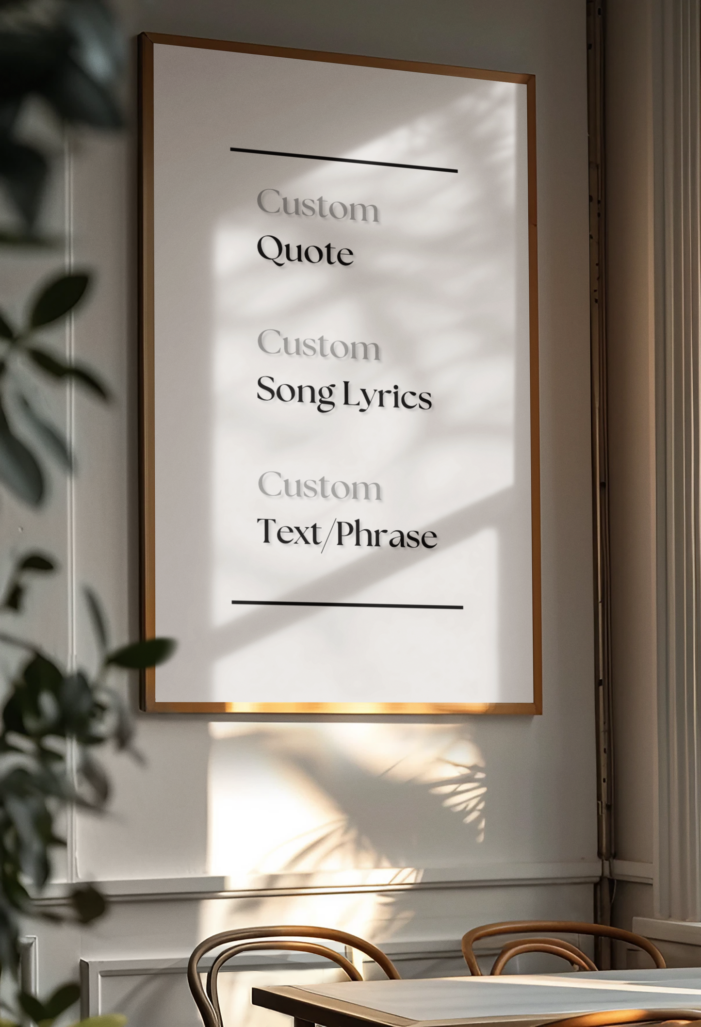 A framed wall art print with customizable quote, song lyrics, and text placeholder text, displayed on a wall in a modern dining room setting with natural light and leaf shadows.