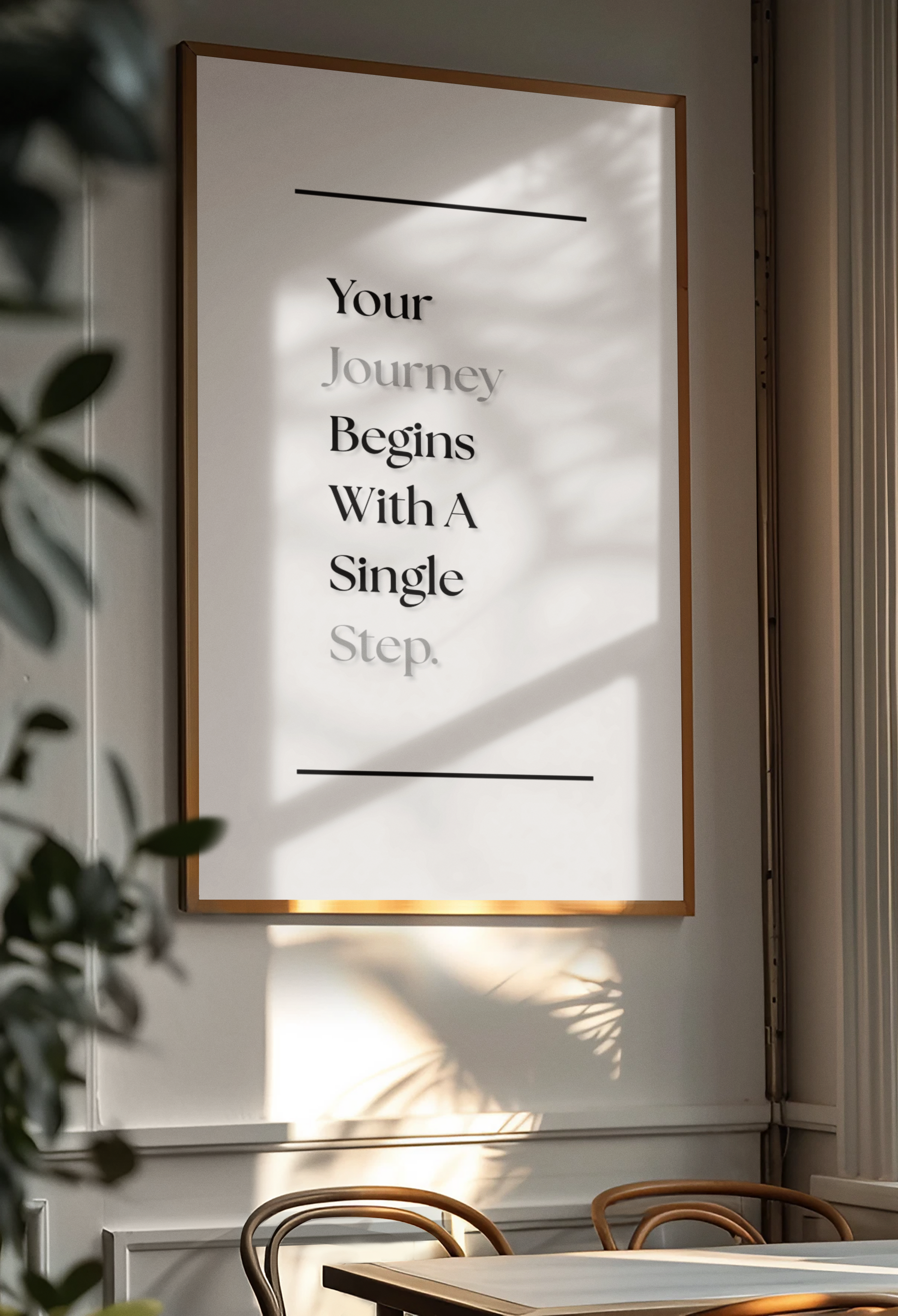 A framed motivational wall art print hanging on a wall in a dining room. The print features the text 'Your Journey Begins With A Single Step'.