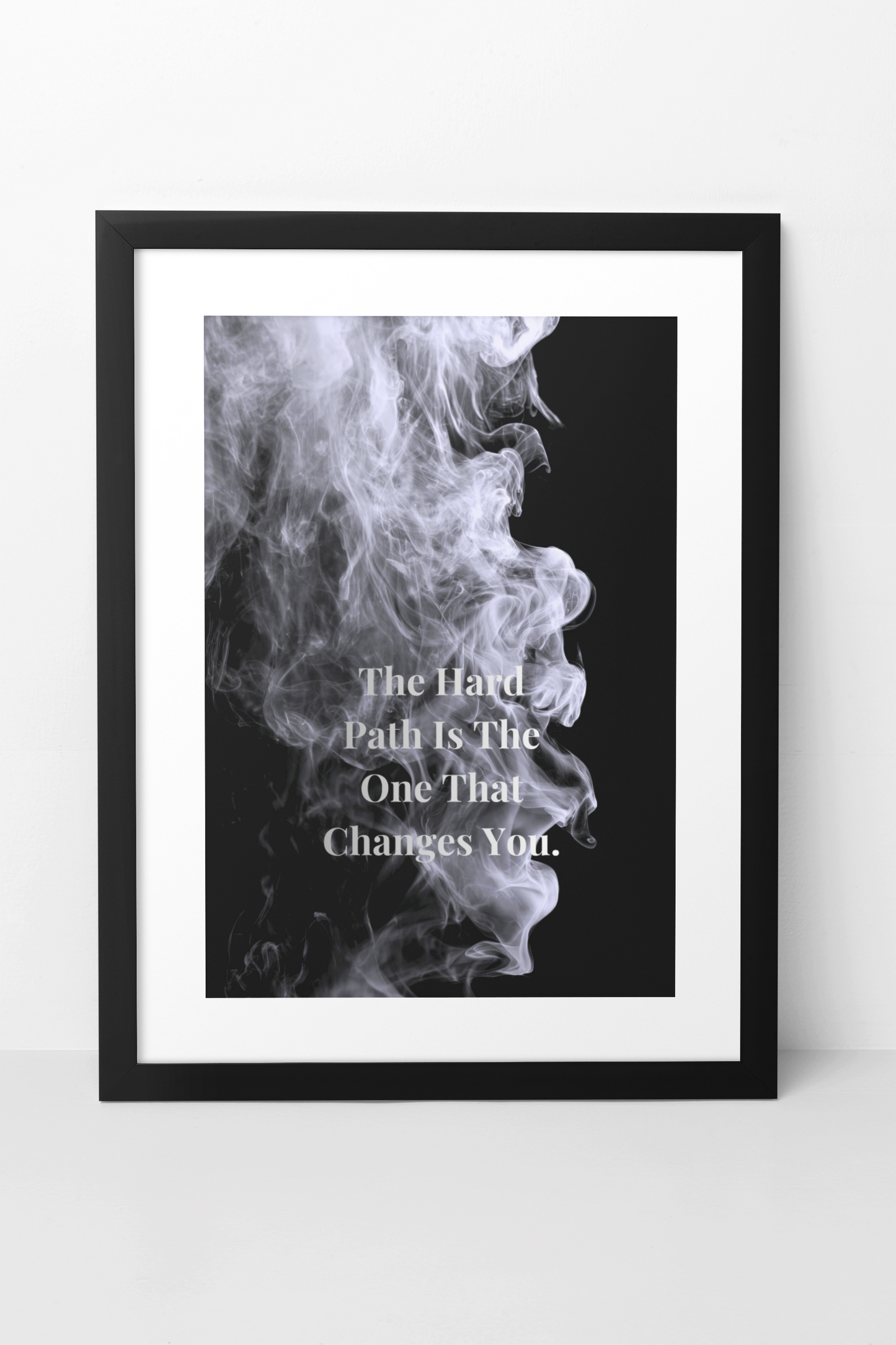 Framed artwork with smoke design and text 'The Hard Path Is The One That Changes You' on a white background