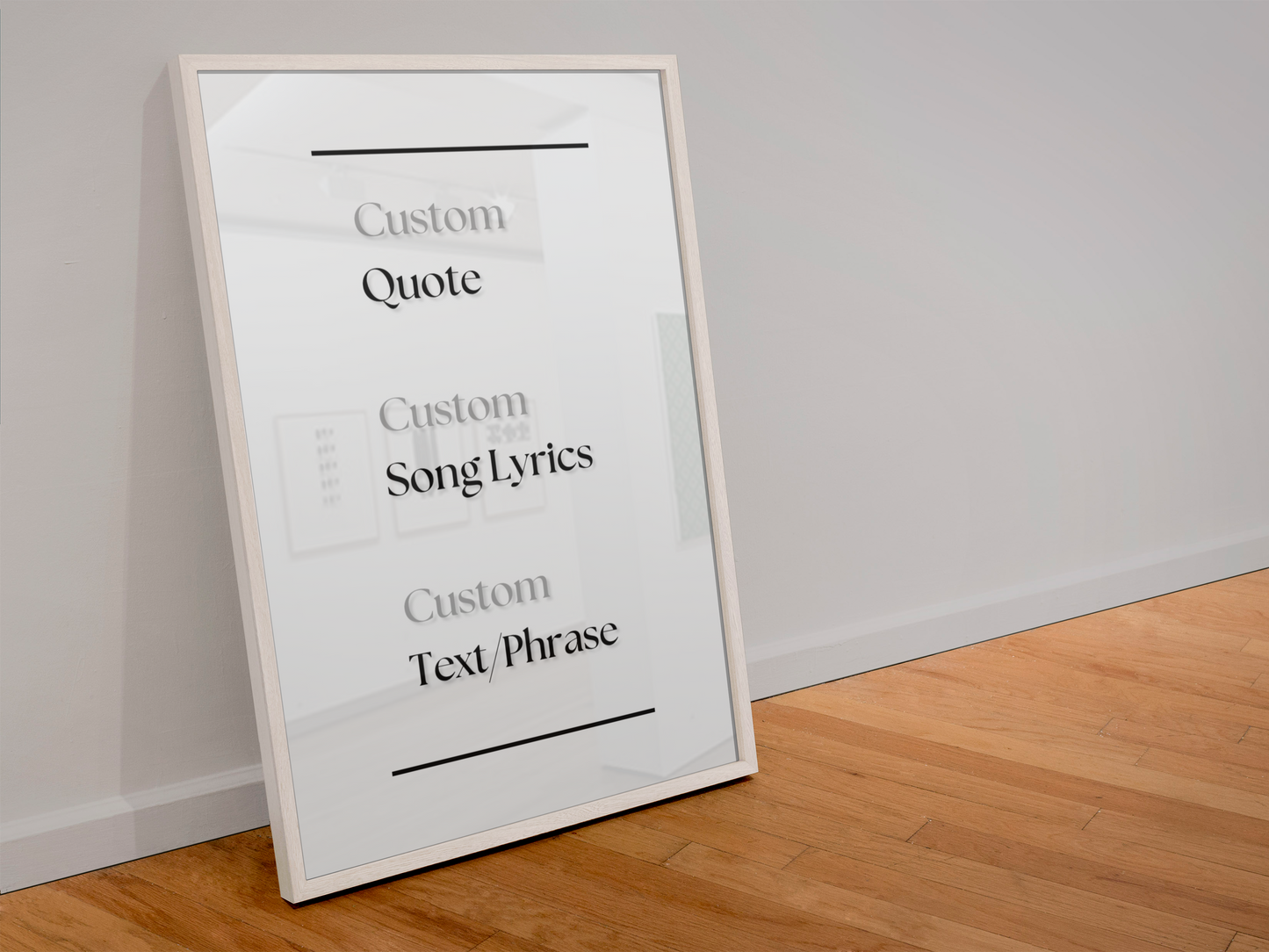 A white-framed custom quote print leaning against a white wall on a light wood floor. The print features placeholder text reading 'Custom Quote', 'Custom Song Lyrics', and 'Custom Text Phrase' with thin black horizontal lines.