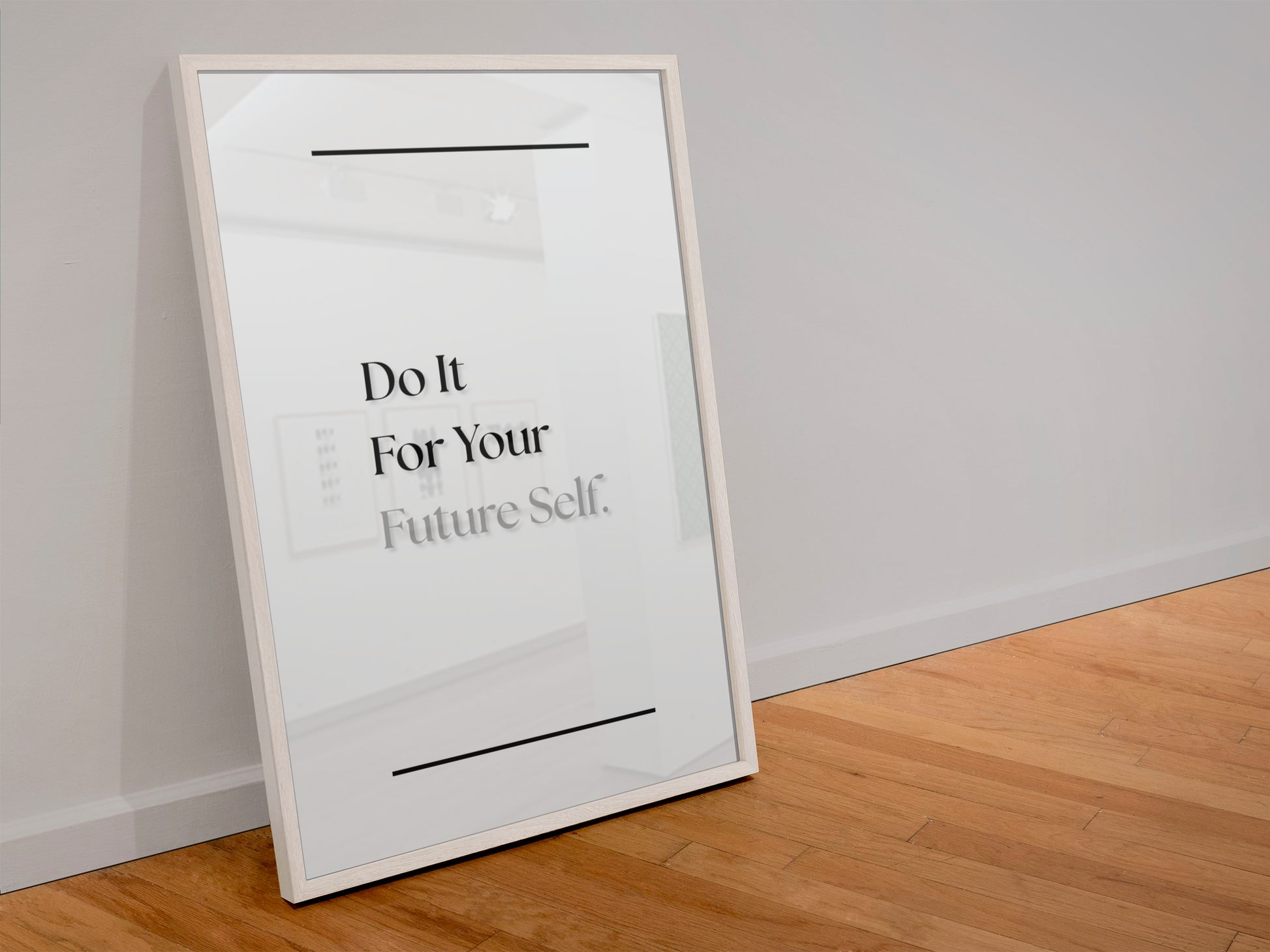 A framed motivational poster leaning against a light gray wall on a wooden floor. The poster has a white background with black text reading 'Do It For Your Future Self.