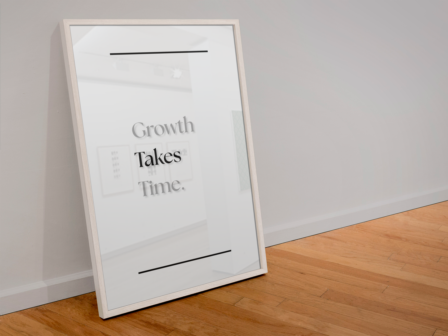 A large framed wall art print leaning against a light gray wall on a light wood floor. The print has a white background with the text 'Growth Takes Time.