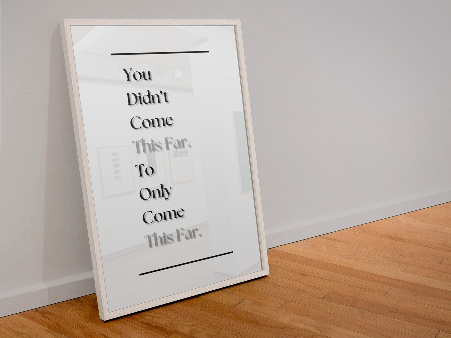 A framed typographic wall art print leaning against a white wall on a light wood floor. The print has black text reading 'You Didn't Come This Far, To Only Come This Far.